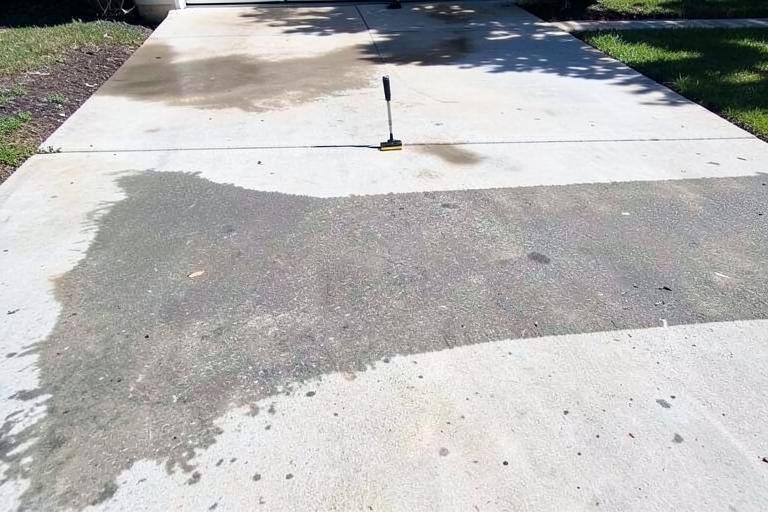 Illustration of a driveway part way through a concrete clean, clean concrete beside grey grime